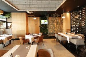 a restaurant with tables and chairs and wine bottles at Royal G Hotel & SPA 4 Star in Durrës