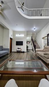 a living room with a couch and a tv at Marwa in Kannur
