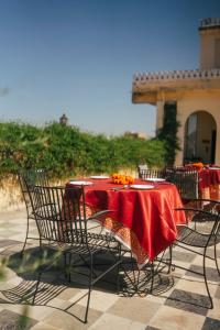 a table with chairs and a red table cloth at Hotel Bissau Palace in Jaipur