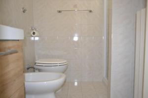 a bathroom with a toilet and a sink and a shower at Roberta Apartment in Marcelli