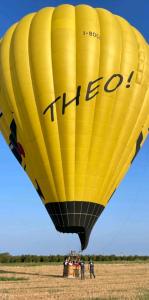 a group of people standing under a yellow hot air balloon at Hotel Guesthouse MASSENA in Genoa +55 photos