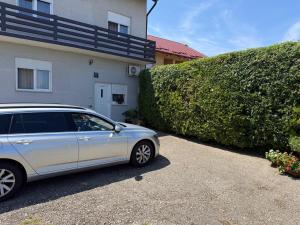 a silver car parked in front of a house at Jetlag Bradić in Velika Gorica