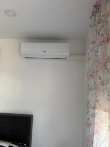 a air conditioner in a room with a curtain at Jetlag Bradić in Velika Gorica