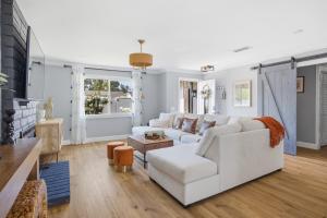 a living room with a white couch and a table at Laguna oasis Pool, Jacuzzi, Sauna in Laguna Hills