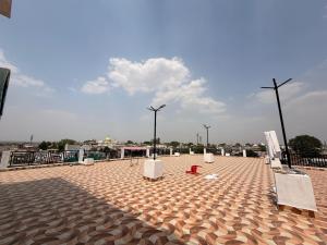 a large plaza with benches and street lights on it at Hotel A3cube in Panna