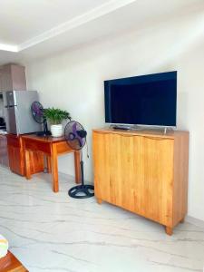 a living room with a flat screen tv on a wooden cabinet at Unit 8F-34 Megatower Residences 3 in Baguio