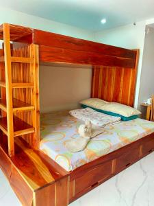 a teddy bear sitting on top of a bunk bed at Unit 8F-34 Megatower Residences 3 in Baguio
