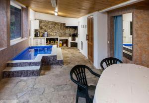 a room with a table and chairs and a swimming pool at Quinta Santo António in Sintra