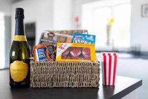 a basket of food and a bottle of champagne at Woodside Barn in Newmacher