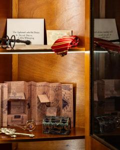 a shelf with a bunch of boxes on it at La Suite Magique du Sorcier in Nîmes