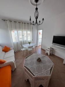 a living room with a couch and a table at Appartement à Miramar in Martil