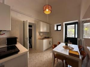 a kitchen and dining room with a table and chairs at Tenuta Moffa in Tramonti