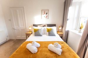 a bedroom with a bed with towels on it at Beach House in Thurso