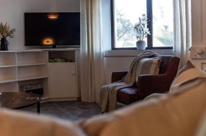 a living room with a couch and a tv at Beach House in Thurso