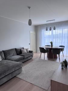 a living room with a couch and a table at Kukerpuu Kinnisvara in Raadi +12 photos
