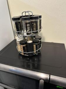 a bunch of cups sitting on top of a microwave at Afternoon checkout in Moorhead