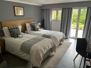 a bedroom with two beds and a window at Les Hortensias in Lantosque +41 photos