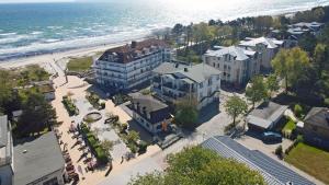 an aerial view of a building next to the beach at Bella Casa 42 - SternenMeer in Juliusruh