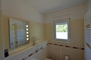 a bathroom with a tub and a sink and a window at Bella Casa 34 - Strandblick in Juliusruh +11 photos