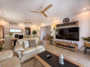 a living room with a couch and a tv at Villa Claudia by Hello Homes Sitges in Sitges