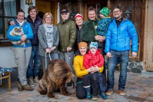 a group of people posing for a picture with a dog at Almhof-Reithof Pitztal in Sankt Leonhard im Pitztal