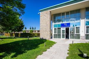 a building with a sign on the front of it at Chianti Village - Free Parking & Pool in Tavarnelle Val di Pesa