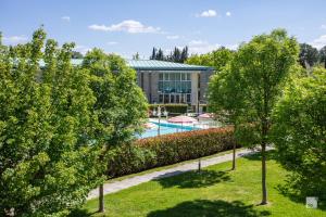 an aerial view of a building with a pool and trees at Chianti Village - Free Parking & Pool in Tavarnelle Val di Pesa