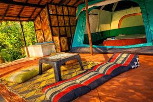 a rug on the floor of a room with a tent at Flower Power Farm Village in Ko Phayam +85 photos