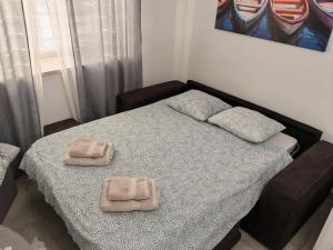 a bedroom with a bed with two towels on it at Studio apartman Luka in Pomer