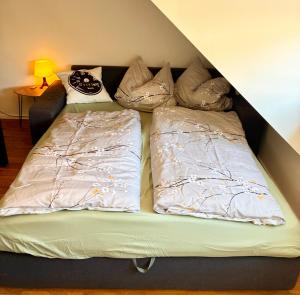 a bed with two pillows on top of it at Haus Güldengossa in Großpösna