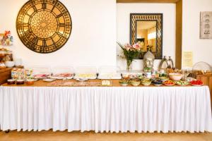 a table with food on it in a room with a mirror at Hotel Schloßschenke in Idar-Oberstein