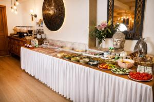 a buffet with many plates of food on a table at Hotel Schloßschenke in Idar-Oberstein +107 photos