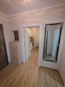 an empty room with a mirror and a dresser at Mountain View Apartment in Sofia