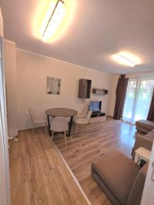 a living room with a table and chairs and a couch at Mountain View Apartment in Sofia