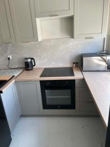 a kitchen with a sink and a stove top oven at Modern Apartament Zakole in Konin