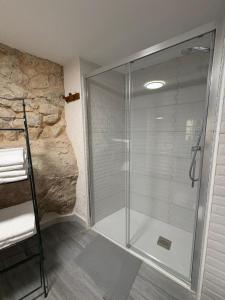 a shower with a glass door in a bathroom at Casa Cueva Toni in Alcalá del Júcar +29 photos