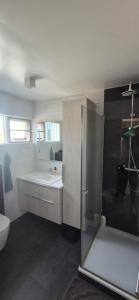 a bathroom with a tub and a sink and a toilet at Gunnlaugsgata in Borgarnes