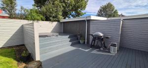 a patio with a fence and a bench on it at Gunnlaugsgata in Borgarnes