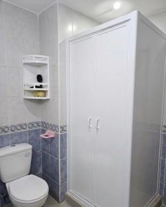 a bathroom with a white toilet and a shower at مراكش تامنصورت in Aït Ali