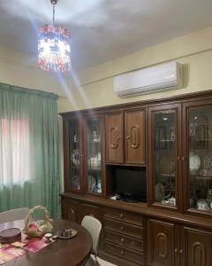 a dining room with a table and a chandelier at مراكش تامنصورت in Aït Ali