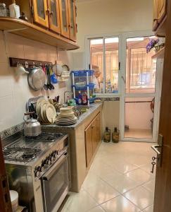 a kitchen with a stove and a counter top at مراكش تامنصورت in Aït Ali