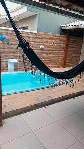 a hammock is hanging over a swimming pool at Unamar Beach in Cabo Frio