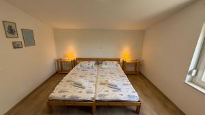 a bedroom with two beds and two lamps in it at Private Villa Bonaventura with Pool & Jacuzzi & BBQ for Families & Groups near Split in Donja Mala +31 photos