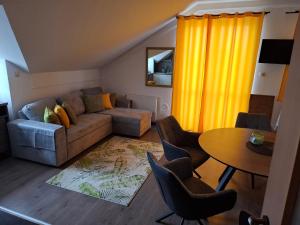 a living room with a couch and a table at Lemon Garden Villapark in Bükfürdő +45 photos