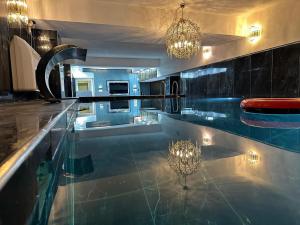a kitchen with a counter top with a chandelier at KRAL GRAND OTEl in Istanbul
