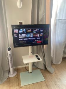 a computer monitor on a stand in a room at Casa Soden, Artful living close to Frankfurt in Bad Soden am Taunus