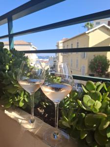 two glasses of white wine sitting on a window sill at Cannes à Pied in Cannes