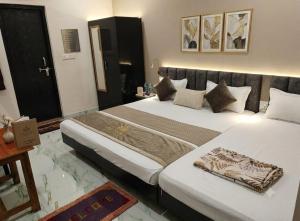 a hotel room with two beds in a room at Hotel Shree Rameshwaram Near by All Temple in Ayodhya