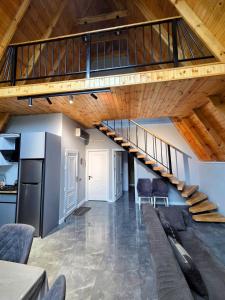 a staircase in a living room with chairs and a kitchen at U seymura qecres in Qǝçrǝş +14 photos