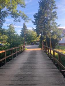 a bridge over a road with cars on it at Ostrowo Młyn in Wągrowiec